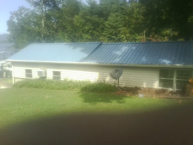 Blue metal roof running the length of a single story home in Eighty Four