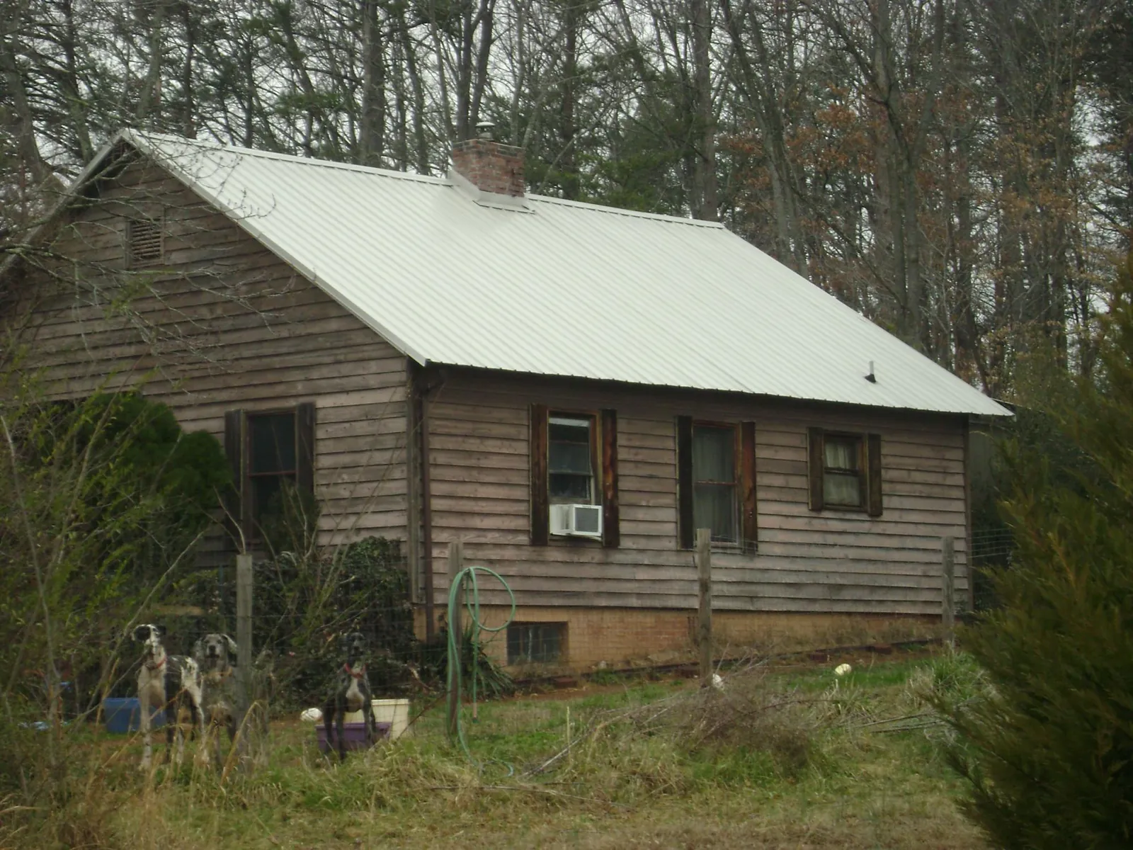 White metal roof on an old wood sided farmhouse, from a Metal Roof Installation job in Eighty Four